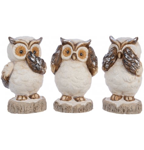 Speak no evil, hear no evil and see no evil terracotta owl ornaments, each with a sprinkling of festive glitter.
