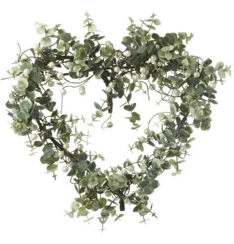 A wispy heart shaped wreath with artificial leaves and pearl berries.