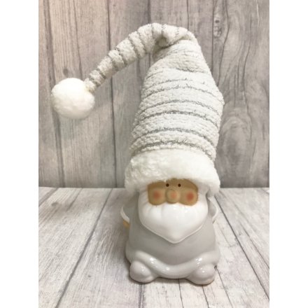 Small standing white Santa with tall silver detailed hat