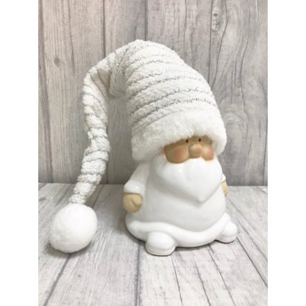 Standing white Santa with tall silver hat.
