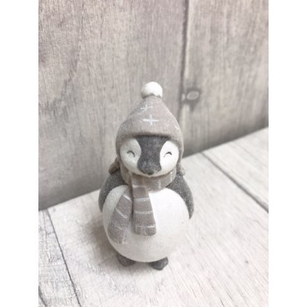 An adorable standing penguin figure with a velvet finish. Complete with a snowflake decorated hat and stripy scarf. 