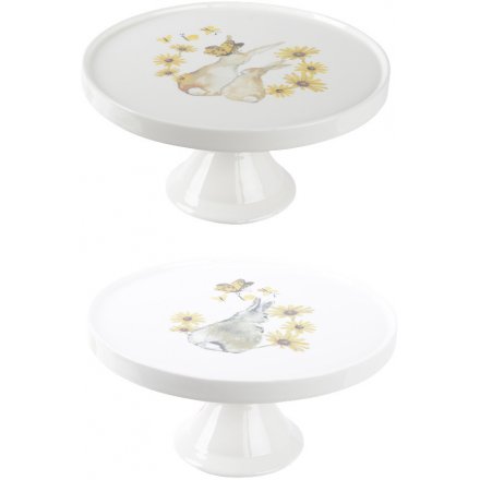 A mix of 2 bunny design cake stands. Each is decorated with a whimsical floral and butterfly design. 