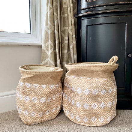 A set of 2 round storage baskets, complete with a natural stitched design and diamond pattern 