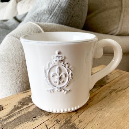  A beautifully smooth glaze finished ceramic cup, complete with a embossed Fleur De Lis