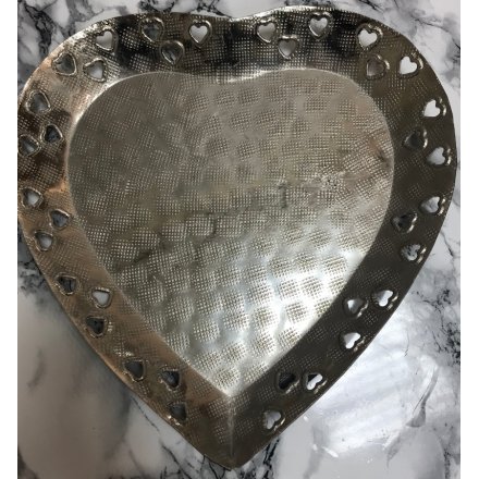 A rough finished and distressed silver set heart shaped plate, decorated with additional heart edges 