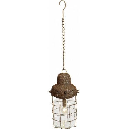 A unique hanging lamp with a rustic metal finish. Hung from a chain.