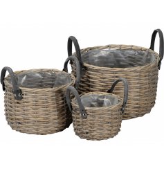 A set of 3 country living woven baskets with grey handles. Each basket has a plastic lining