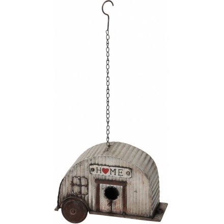 A rustic corrugated metal caravan birdhouse with a charming HOME sign