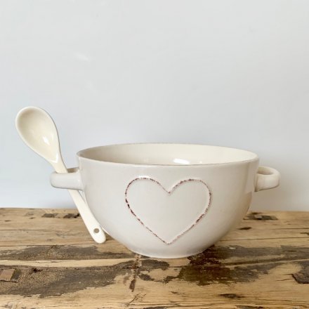A stylish shabby chic bowl with a heart design and twin handles.