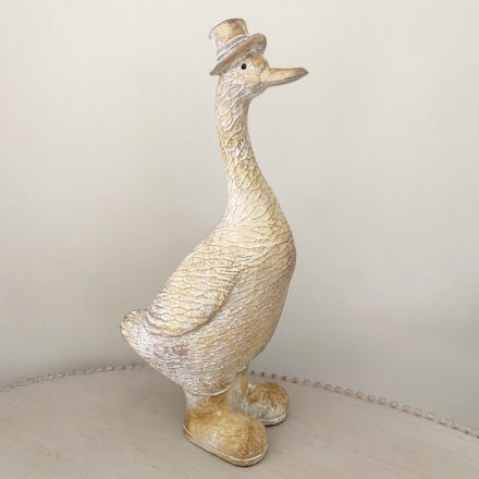  Decorated with a fancy top hat and booties, this charming duck figure will tie in with any additional home decor or dis