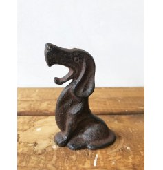 A cast iron rustic dog shaped bottle opener
