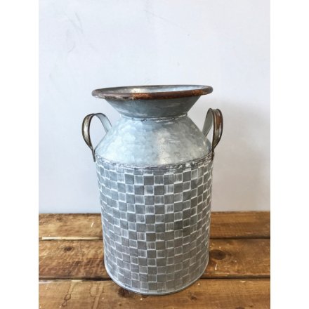 A rustic style metal churn with twin handles. Decorated with a textured square pattern surface.
