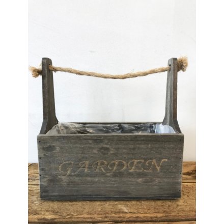 A rustic style wooden trough planter with a chunky rope carry handle and garden sign.