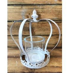 An antique style white metal crown with candle holder.