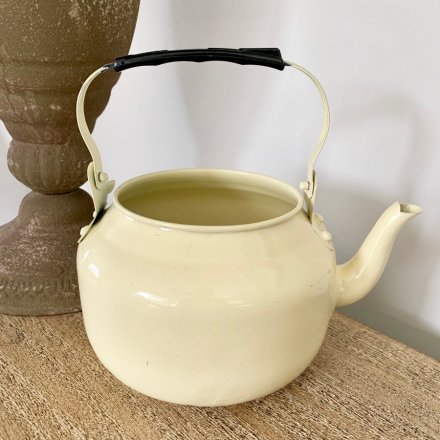 A charming and unique vintage teapot planter with handle. 