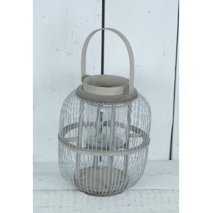 A chic grey metal lantern with handle. Adding ambience to the home, garden and special events.