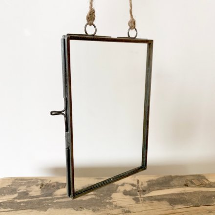 A vintage style metal photo frame with jute string hanger. A unique gift item and home accessory.
