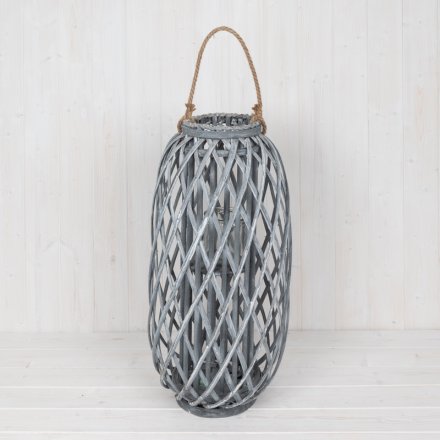 A large woven rustic inspired lantern set with a chunky rope handle for added character 