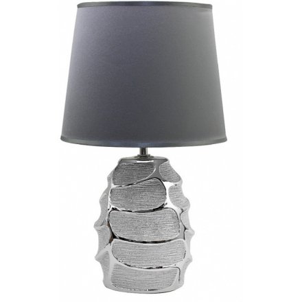 A stylish table lamp with a fabric shade. A beautiful textured lamp base with grey shade.