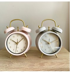 An assortment of 2 chic pink and grey pastel coloured clocks with gold detailing. 