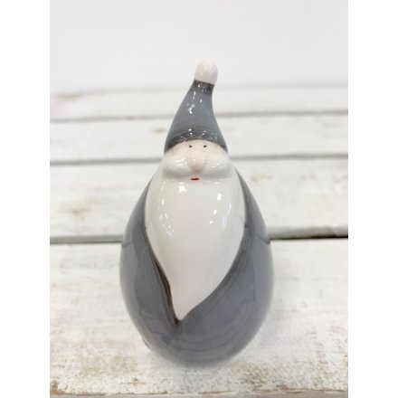  A charmingly plump ceramic Santa figure complete with a smooth glaze look and grey tone 