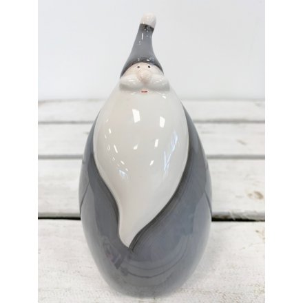  A charmingly plump ceramic Santa figure complete with a smooth glaze look and grey tone 
