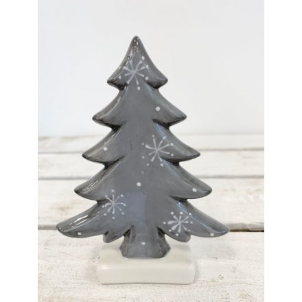 A grey toned ceramic tree decoration complete with a distressed finish and white snowflake decal 