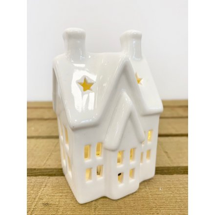 A simple white toned ceramic house decoration with an added LED glowing centre