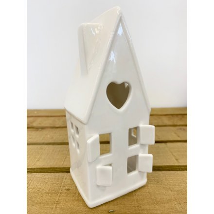 A ceramic based house decoration with an added space to put a t-light 