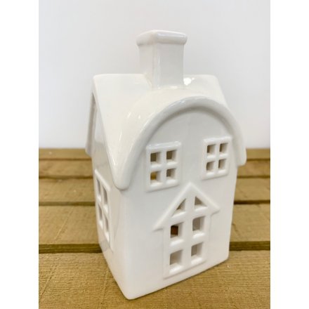  A simple white toned ceramic house decoration with an added tlight holder space 