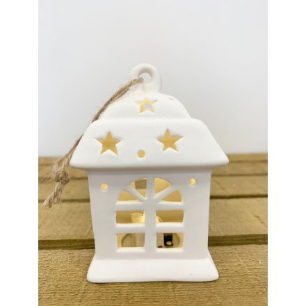 A charming little ceramic hanging house with a fitted warm glowing LED centre 