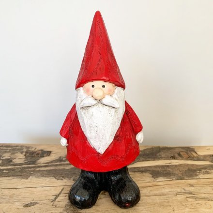 A resin based standing Santa Figure, set with a bright and festive themed red tone and finished with a carving decal 