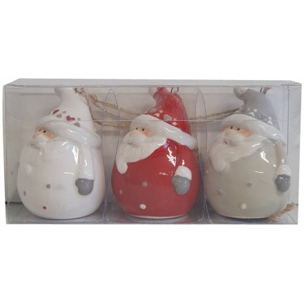 A set of adorable hanging Santa figurines in red, white and grey with delicate painted detail. 