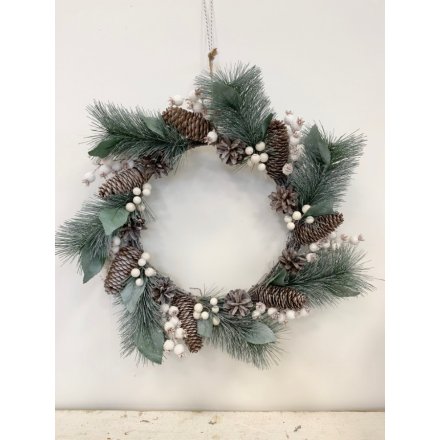  A charmingly simple round wreath built up of Alpine branches, pinecones and berries 