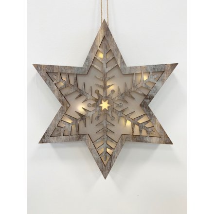 A hanging natural toned wooden star with an added cut snowflake centre decal and beautiful warming glow LED centre 