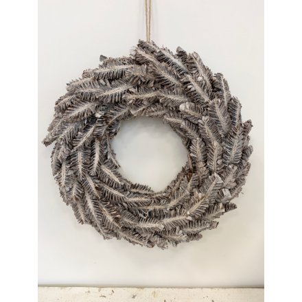A grey washed toned wreath with an added frosted decal 