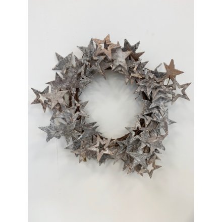   A round wreath made up of assorted sized bark stars coated with a sparkly silver effect 