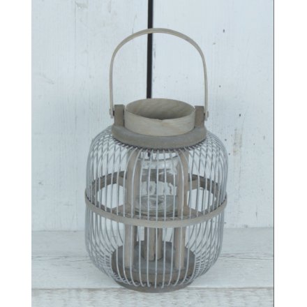 A beautifully contemporary looking lantern with a glass inset and white washed finish 