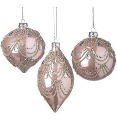  A gorgeous assortment of glass baubles set in a shiny blush pink tone, with their assorted shapes and champagne gold gl
