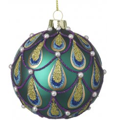 A beautifully decorated glass bauble set in a matte green tone 