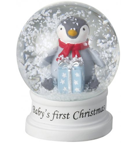 An adorable miniature snow globe featuring a snow covered penguin with gift. 