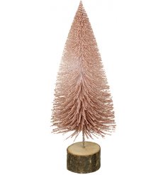 A sparkly pink bristle tree on a wooden bark base 