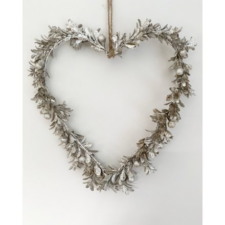  A small hanging heart wreath decorated with champagne toned mistletoe leaves