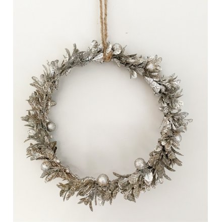 A champagne toned wreath made up of mistletoe leaves 