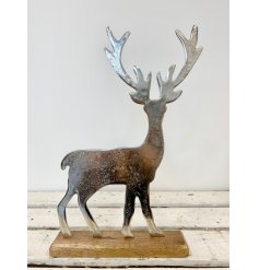A rustic style stag ornament set upon a chunky wooden block. An on trend, seasonal gift item and interior accessory.