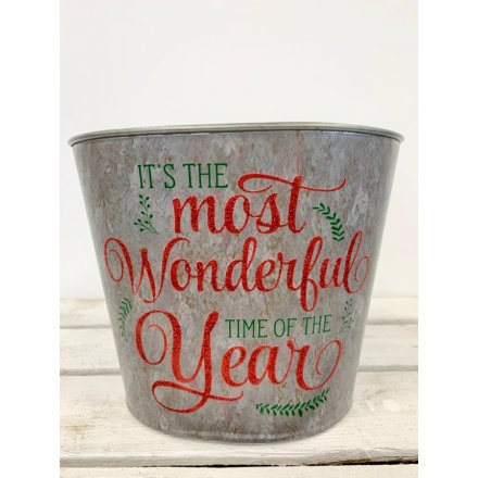 It's the most wonderful time of the year. A rustic metal planter with a seasonal red glitter slogan.