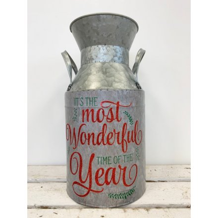 A rustic style metal planter with a red glitter traditional slogan.