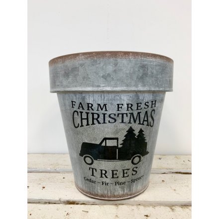 A rough luxe grey metal planter with a farm fresh Christmas slogan.