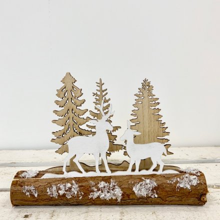 A charming and rustic snowy woodland scene set upon a log. A unique Christmas ornament for the home.