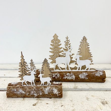 A rustic Christmas decoration. A woodland scene set upon a snow dusted log. 